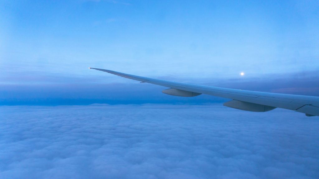 views of the blue sky, clouds and plane wing from the window seat