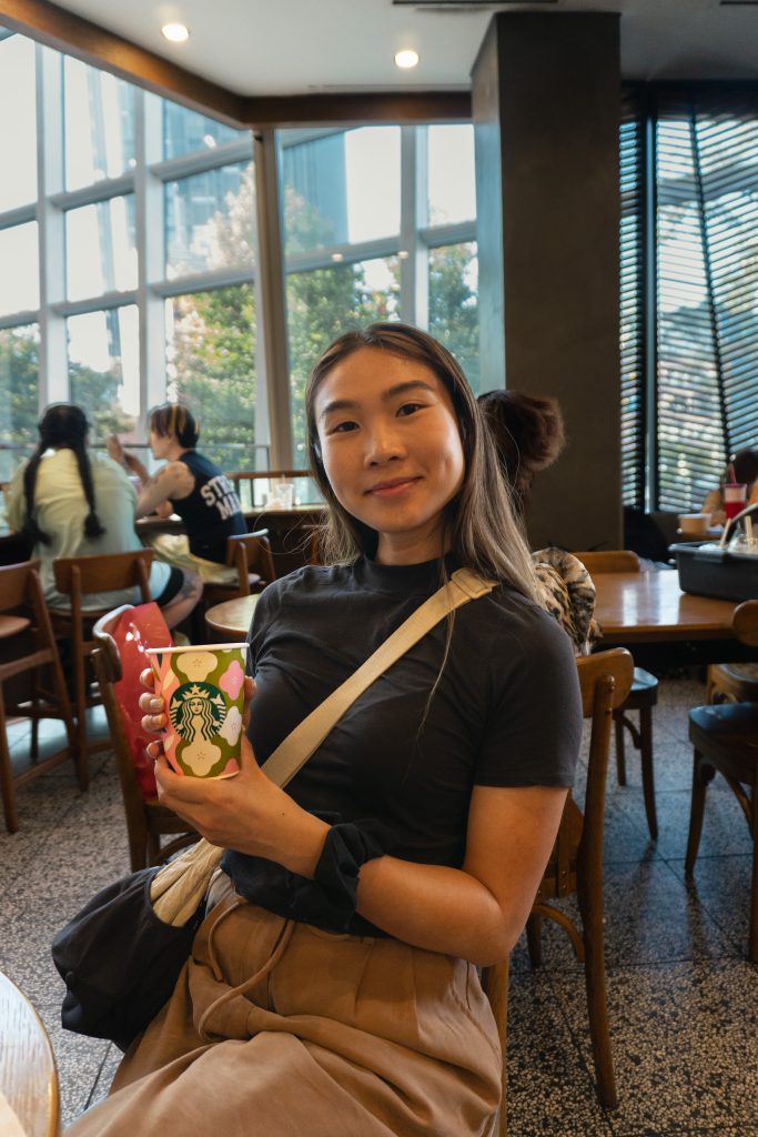 Girl sitting at starbucks drinking coffee